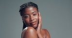 Black woman, touch face and skincare in studio with texture, pride and results on background. African girl, smile and mockup space in portrait, dermatology or beauty with natural cosmetics in Nigeria