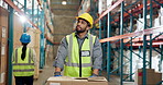 Thinking, man and box at warehouse for distribution, shipping and inventory management. Male person, walk and pointing with package for logistics, industrial stock and inspection of quality assurance