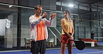Padel court, people and coach for training, help and teaching to practice swing together. Mature man, woman and tennis trainer with racket for exercise, learning sports or talk for game demonstration