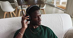 Relax, music and black man with headphones in living room, streaming service or sound above in house. African person, audio and listening to radio in home for chill, playlist and hip hop song