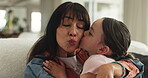 Bonding, mom and child in home, kiss and embrace on couch, smile and affection on weekend in lounge. Woman, love and hug daughter in living room, single parent and happy with kid on break in house