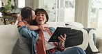 Mom, girl and surprise with tablet on sofa for hug, happy or kiss with choice for movies in home. People, mother and daughter with tech, application and embrace with smile for bonding at family house