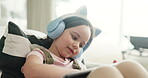 Online, elearning and child with tablet, headphones and listening to lesson on social media or home. Education, growth and development of girl with tech for knowledge, browsing and studying with app