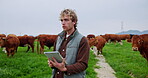 Tablet, cow and thinking with man on farm as herd record manager, agriculture and tracking animal breed. Livestock production, online milk yield report and reflection with person in countryside