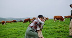 Cow, running and hug with family on farm for cattle agriculture, love and support. Sustainability, happiness and bonding with parents and child on countryside field for growth and environment