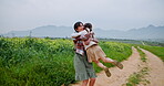 Spinning, hug and mother with daughter in countryside field for support, bonding or agriculture. Environment, connection and love with woman and child on nature path for sustainability and family