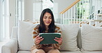 Woman, happy and reading in home with tablet, digital app and notification for good news. Female person, smile and fintech on couch with technology, online and connection for successful application. 