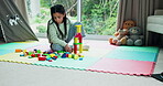 Thinking, child and playing with blocks at house for learning, fine motor skills and problem solving. Kid, girl and relax with educational toys for education, cognitive development and building games