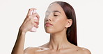 Studio, beauty and woman with face spray, hydration or facial mist for healthy skin and moisturizer. White background, cosmetics and person with product for makeup, self care and skincare with water
