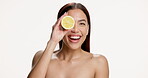 Face of woman, lemon and smile in studio for skincare, vitamin c and natural beauty for wellness. Portrait, happy person and dermatology with citrus fruit, skin glow and space on white background.