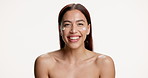 Face, skincare and woman in studio with cream, hydrate and spf protection for skin health. Dermatology, smile and girl with cosmetics, sunscreen lotion and facial moisturiser on white background.