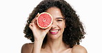 Happy woman, face or skincare with grapefruit in studio for vitamin C on a white background. Portrait, female person or model with smile, natural organic fruit or detox for antioxidant or nutrition