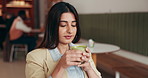 Woman, phone and drink at cafe with thinking, reflection and texting with coffee break for remote work. Business person, smartphone and tea cup with mobile app, contact or social media at restaurant