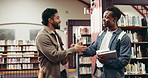University, students and handshake with books in library for study material, assignment chat or info. Friends, people or course textbooks at college for exam preparation, PHD discussion and education