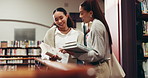 College, students and talking in library with books for language course, project and studying literature. University, people and women in bookshop with chat for textbook, reading task and assignment.