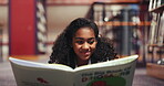 Education, happy and child with reading book in library, learn vocabulary and language development. Smile, encourage creativity and girl with dinosaur knowledge, boost memory and prehistoric interest