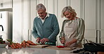 Old couple, chop vegetables or cooking in kitchen with knife for recipe, bonding or thanksgiving dinner. Elderly, people or cut ingredients in home with meal prep, food discussion or healthy marriage