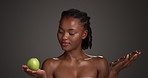 Fruit, chocolate or woman in studio with choice, antioxidant or hydration for skincare benefits. Apple, cocoa or black person with food decision for clear skin, beauty or wellness on gray background.