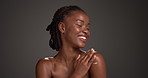 Body lotion, happy or black woman with skincare in studio, hydration or moisturize benefits in cream Apply, smile or person with wellness product for skin glow, self care and space on gray background