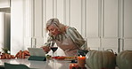 Cooking, tablet and thanksgiving with old woman in kitchen of home for instructions on meal prep. App, online recipe and reading with senior person at counter in apartment for holiday tradition