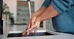 Person, hands and washing with water splash in kitchen for personal hygiene or disinfection in home. Rinse, skin and sink with soap, tap or faucet for cleanliness, bacteria or germ removal in house
