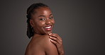 Shoulder, skincare and smile with face of black woman in studio for beauty, body care and clear skin glow. Dermatology, shine and hydration with person on dark background for space and aesthetic