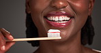 Black woman, mouth and teeth with toothbrush in studio for dental hygiene on a gray background. Closeup, female person or African model with smile or bamboo brush for fresh breathe, gum or oral care