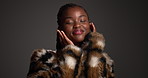 Skincare, face and happy black woman with beauty makeup for style, glamour and glow. Fur coat, trendy and model with lipstick cosmetics, luxury aesthetic and touch skin on dark background in studio