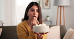 Woman, eating and watching tv in home with popcorn for entertainment, film series or relax on weekend. Surprised, female person and snack in apartment for movie, streaming service and documentary.