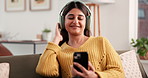Dance, smartphone and woman with headphones, audio streaming and stress relief. Music, home and person on couch, cellphone or dancing in lounge, sounds and smile with digital app, song and relax