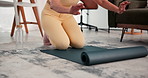 Hands, woman and roll yoga mat on floor for home workout, start exercise routine and preparation. Yogi, morning and person with pilates equipment in apartment for getting ready, wellness and fitness