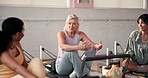 Smile, pilates and women in studio, conversation and feedback for progress, challenge and support. People, instructor and group with discussion, health and break with technique, fitness and wellness