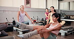 Pilates, class and women in studio with workout, mobility or posture improvement in body wellness. Support, leg stretching and instructor in club with reformer, muscle or core tone in group exercise.
