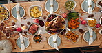 Food, table setting and thanksgiving in dining room of home for feast or roast dinner from above. Chicken, meal and spread with cuisine in apartment for celebration, holiday tradition or season