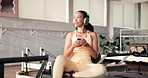Happy woman, headphones and phone at pilates studio for exercise, thinking and streaming at gym. Person, smile and listen to music with smartphone, app and subscription for reflection at fitness club