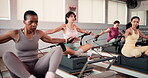 Women, instructor and reformer machine in class for fitness, strength training and arm workout. People, personal trainer and equipment for stretching exercise, improve posture or mobility flexibility