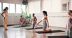 Demonstration, fitness and woman in class with pilates instructor for course, lesson or wellness routine. Exercise, floor or training with personal trainer and students in health club for workout