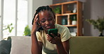 Upset woman, talking and phone call on sofa for conversation, gossip and speaking in living room. Stressed, black person and tech on couch with loudspeaker for contact, discussion and chat in home.