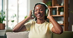 Dance, headphones and happy with black woman on sofa for streaming service, song playlist and energy. Music, audio subscription and connection with person in living room of house for radio and album