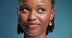 Face, remember and thinking with black woman in studio for contemplation, memories or nostalgia. Future, ideas and question with happy African person on blue background for planning or vision