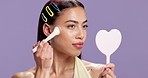 Makeup brush, mirror and woman with aesthetic, beauty product or cosmetics powder in studio. Portrait, facial cosmetology or foundation treatment for dermatology with self care on purple background