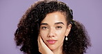 Girl, skincare and face in studio with beauty, touch and curly hair on purple background. Healthy skin, dermatology and glow for wellness, self care and natural cosmetics for female person with afro