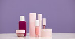 Bottle, cosmetics and advertising for beauty in studio, product and cosmetology mockup on purple background. Skincare, container and marketing for dermatology selection, makeup choice or presentation