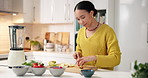 Woman, chopping board and fruit in kitchen for smoothie, meal prep and strawberry for benefits. Person, chef and cutting organic ingredients for diet, nutrition or weight loss for wellness at house