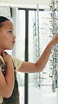 Optometry, girl and kid with glasses, decision and selection with wellness, clear vision and options. Customer, prescription eyewear and happy child with choice, optometrist and ophthalmologist