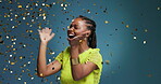 Excited, scream and woman with confetti, studio and celebration for discount offer, success and win. Black person, winner and shouting for good news, happy and announcement of sale or blue background