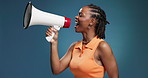 Megaphone, shouting and black woman in studio with news for announcement, information and speech. Happy, space and person with bullhorn for notification, sales and promotion on blue background