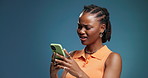 Confused, phone and text message with black woman in studio for communication, post or update. App, contact and doubt with African person on blue background for alert, notification or phishing scam