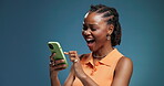 Notification, phone and surprise with black woman in studio for alert, celebration or success. Reaction, reading and wow with happy African person on blue background as winner of online competition
