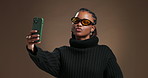 Black woman, selfie and fashion in studio with sunglasses, trendy style and pout on background. African girl, shades and profile picture with kiss, mock up space or content creation for social media
